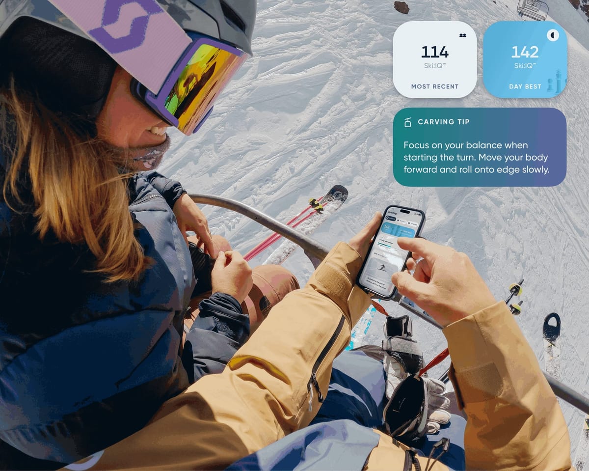 Skiers on a chairlift checking Carv Ski:IQ scores and a carving tip on a phone