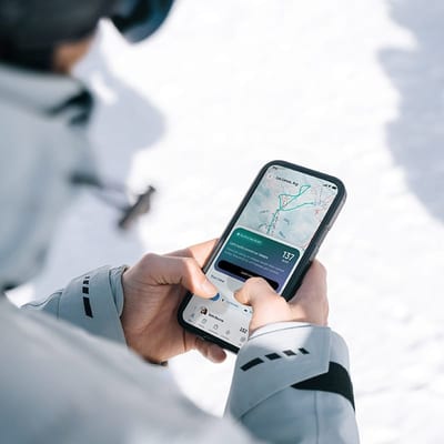Skier checking Carv coaching on their phone on the slopes